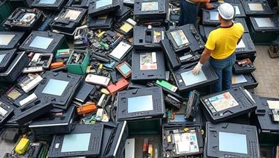 An array of electronic devices being carefully disassembled and sorted for recycling, with workers wearing protective gear and using eco-friendly methods to highlight the sustainable and responsible e-waste recycling process.