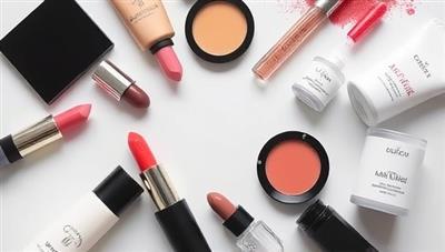An artistic flat lay of customizable beauty product components like lipstick tubes, foundation pigments, and skincare serums arranged in a visually appealing pattern, conveying the concept of personalized beauty creation.