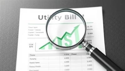 An image of a magnifying glass hovering over a utility bill, with a graph showing potential savings and dollar signs, symbolizing thorough examination and cost-saving opportunities.