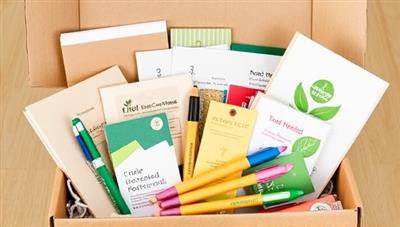 An assortment of eco-friendly school supplies displayed in a subscription box, featuring recycled paper products, plant-based pens, and compostable packaging, highlighting the sustainability and environmental focus of the educational supply service.