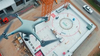 An aerial view captured by a drone showing a construction site with detailed mapping and measurements, highlighting the precision and efficiency of drone surveying technology in action.