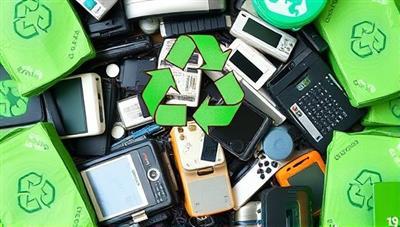 An array of old electronic devices and gadgets being collected for recycling, surrounded by green recycling symbols and eco-friendly packaging, symbolizing the sustainable and responsible approach of EcoCycleTech in tech recycling and e-waste management.