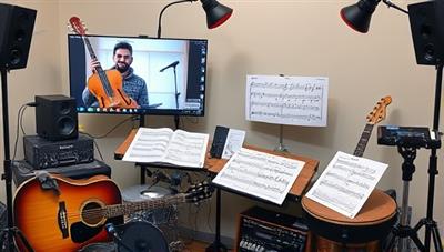 A virtual music lesson setup featuring a student and instructor interacting through video call, with musical instruments, sheet music, and audio equipment visible in the background, creating a dynamic and immersive learning environment for aspiring musicians to master their craft.
