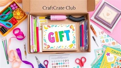 An artistic flat lay photograph of a colorful array of craft supplies, tools, and materials neatly arranged in a subscription box, with a completed craft project as the centerpiece, surrounded by creative elements like ribbons, stickers, and glitter, enticing viewers to unleash their artistic side with CraftCrate Club.