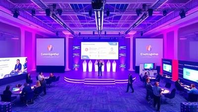 An immersive visual of a virtual event space on EventSphere Online, featuring a virtual stage with keynote speakers, interactive booths for sponsors, and networking lounges for attendees, illustrating a dynamic and engaging online event environment.