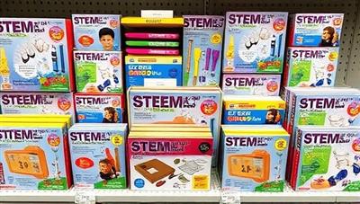 An array of colorful STEM kits neatly arranged on a shelf, with various tools, components, and instruction booklets, conveying a sense of excitement and hands-on learning opportunities for children.