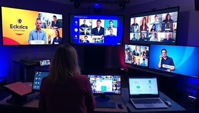 A dynamic virtual event setup featuring a virtual event planner coordinating a live online conference with multiple participants, interactive screens, and branded visuals, showcasing the versatility and professionalism of virtual event management for engaging and impactful online gatherings.