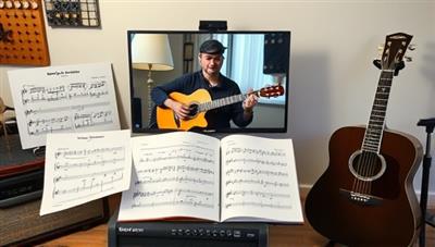 A virtual music lesson scene with a music instructor demonstrating guitar chords on a video call, sheet music and musical instruments in the background, creating an immersive and engaging learning environment for students to develop their musical skills and passion for music.