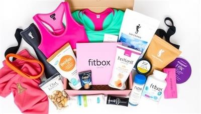 An elegantly designed subscription box filled with colorful workout gear, healthy snacks, supplements, and self-care products, arranged in a visually appealing layout, creating a sense of excitement and anticipation for subscribers opening their personalized FitBox Delights package.
