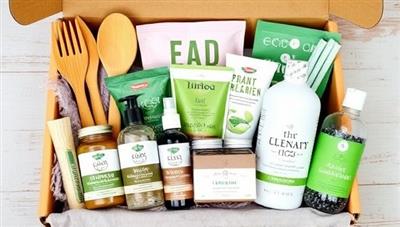 An array of eco-friendly products neatly arranged in a subscription box, including bamboo utensils, organic skincare products, reusable straws, and plant-based cleaning supplies, symbolizing a commitment to sustainable living.