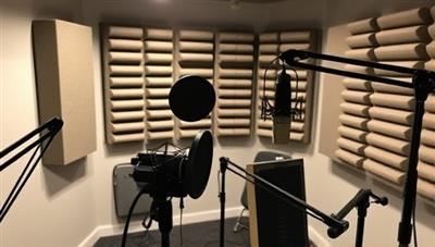 A podcast studio setup with microphones, soundproofing panels, and recording equipment, showcasing a professional and creative environment for hosting writing masterclasses and author interviews in a dynamic audio format.