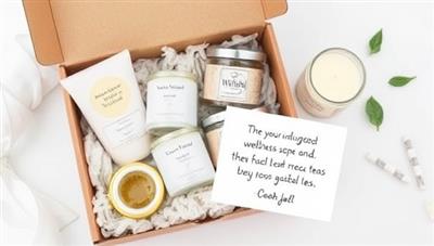 A visually appealing image featuring a WellWish Box filled with luxurious bath salts, scented candles, herbal teas, and a personalized note, creating a serene and indulgent wellness experience perfect for gifting or self-care.