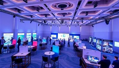 An immersive virtual event platform interface displaying a virtual conference hall with interactive booths, networking lounges, and live webinar sessions, illustrating the versatility and engagement potential of virtual events through a digital event space.