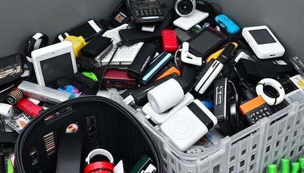 An image of a collection point with various electronic devices and gadgets being sorted for recycling and repurposing, showcasing the eco-friendly and sustainable practices of EcoTech Renew in reducing electronic waste and promoting environmental conservation through tech recycling initiatives.